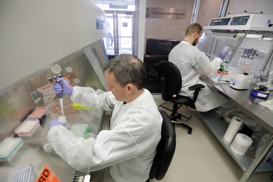 Co-Diagnostics lab technicians manufacture COVID-19 testing kits Friday, March 27, 2020, in Salt Lake City. The company says it has the capacity to produce 50,000 test kits daily from its Salt Lake City facility.