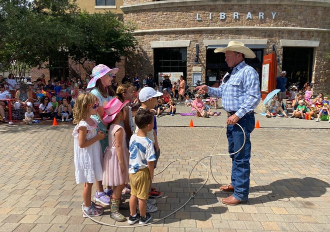 Champion roper Kevin Fitzpatrick corrals some young readers at the Bee Cave Public Library.