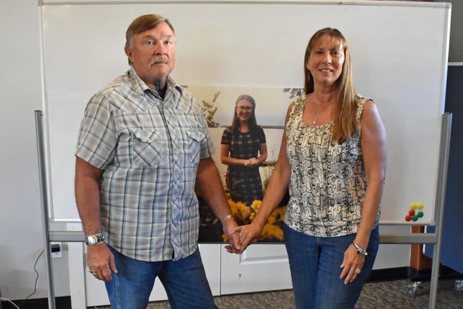 Terry and Mia Montang pose with a photo of their daughter Eden Mariah Montang, who was killed in a shooting at Cornerstone Church in Ames June 2.