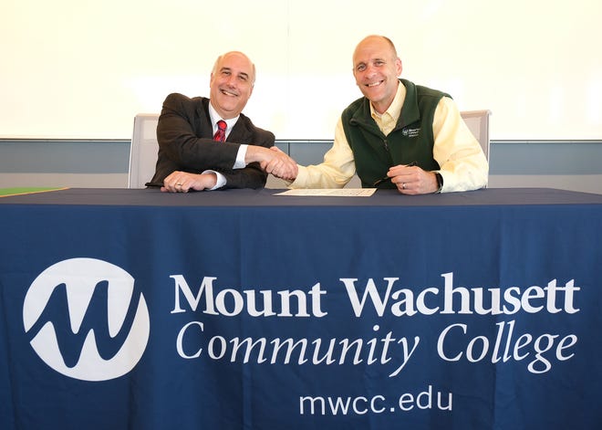 Fitchburg State University President Richard S. Lapidus, left, and Mount Wachusett Community College President James Vander Hooven at the signing ceremony for a new articulation agreement for students pursuing careers as middle and secondary education teachers.