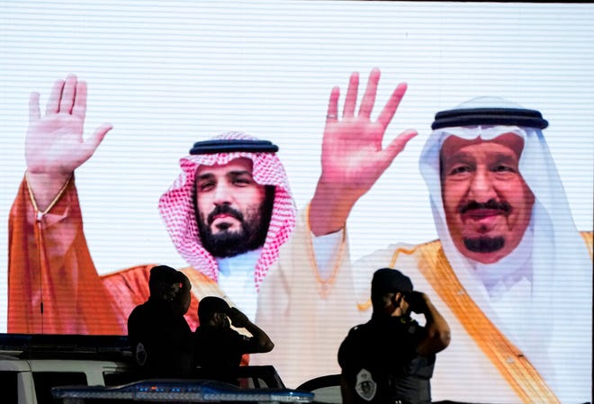 FILE - Saudi special forces salute in front of a screen displaying images Saudi King Salman, right, and Crown Prince Mohammed bin Salman after a military parade in preparation for the annual Hajj pilgrimage, in the Muslim holy city of Mecca, Saudi Arabia, July 3, 2022.Â President Joe Biden will become the first U.S. president to travel directly from Israel to Saudi Arabia. The world will be watching the highly anticipated meeting Friday to see if the gaffe-prone U.S. president and notoriously vengeful Saudi prince can begin repairing a rift between the two strategic partner. (AP Photo/Amr Nabil, File)