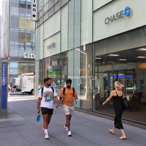 NEW YORK, NEW YORK - JULY 14: People walk past a C