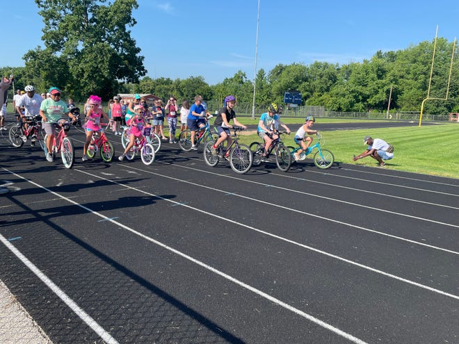 The first bike-riders take off from the starting line Saturday, July 17, 2022 during the OneSpringfield Run/Walk/Bike for Unity at Southeast High School.