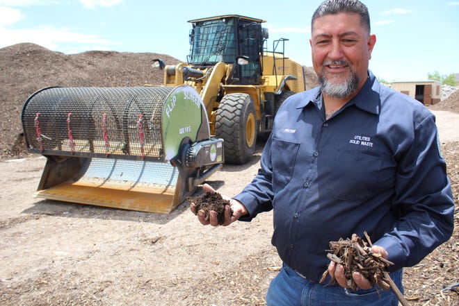Las Cruces Utilities Heavy Equipment Operator Hector Lozoya shows the difference in the mulch, the before and after use of the flip screen, which is shown behind him.
