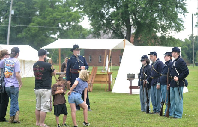 Kevin McNamara (left), Captain in the 41st Ohio Volunteer Infantry, talks to visitors during the Civil War Living History event hosted by the Historic Prospect Place Estate and The G.W. Adams Educational Center.