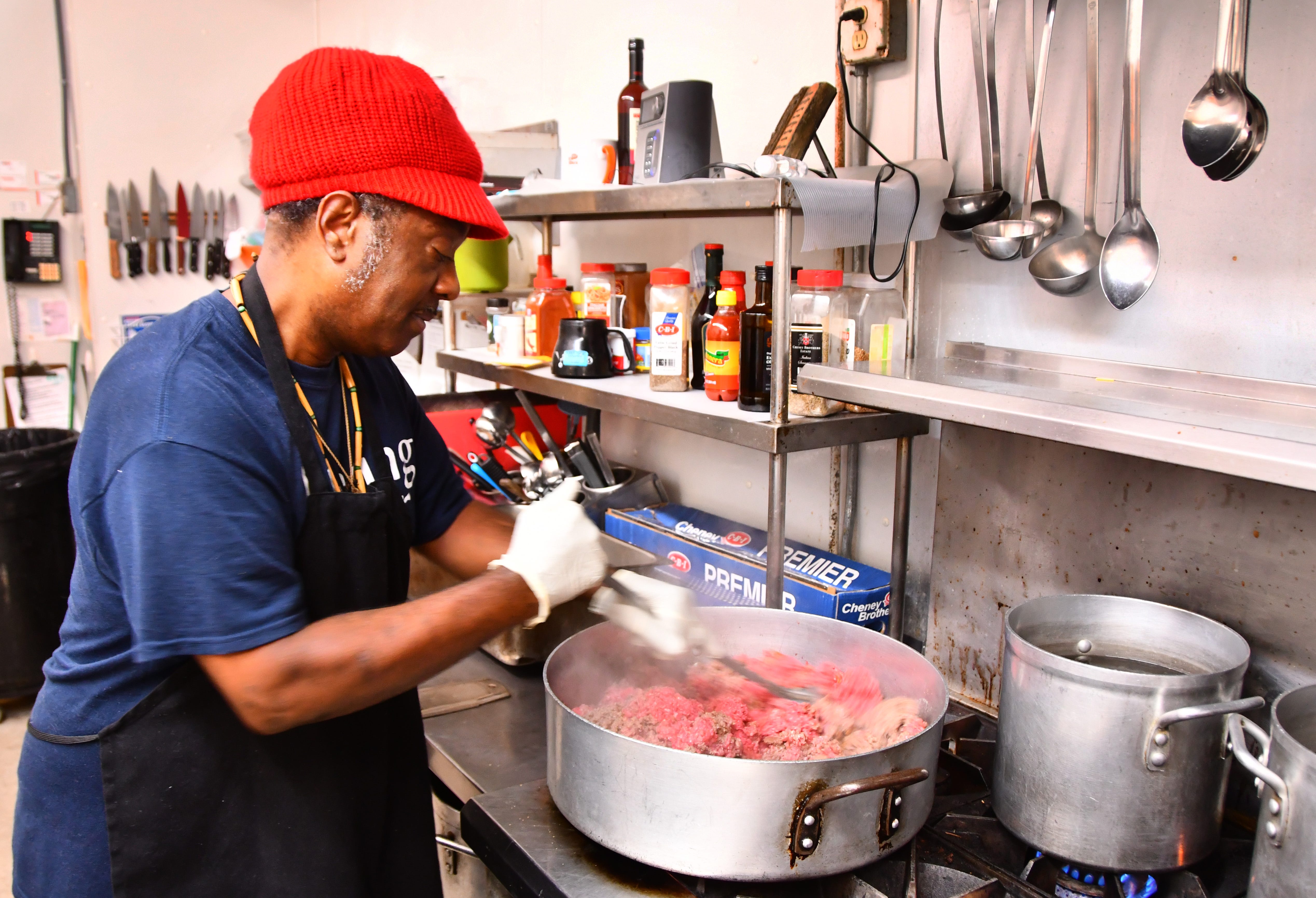 Kitchen manager Wesley Smith prepares lunch of  ground beef with vegetables and gravy over rice, with carrots and a desert. The Central Brevard Sharing Center serves or  passes out meals 365 days a year. 