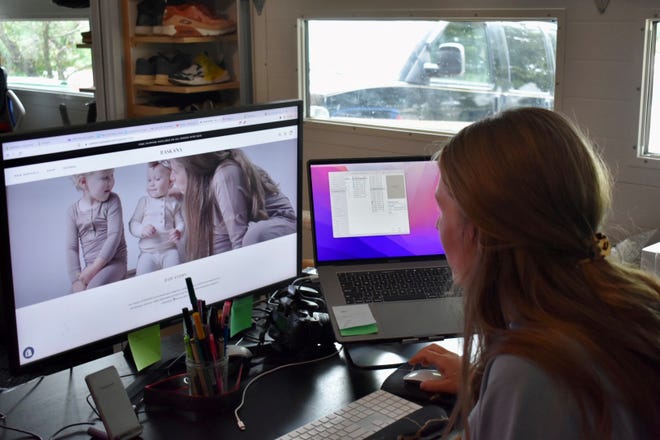 In her basement office, Jessie Daavettila also has an area set up for taking photos of her apparel with her kids.