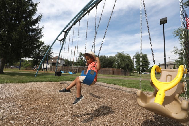 Jalen Robinson, 3, swings on the swingset at Keen Street Park on Friday. The City of Zanesville has finished a $200,000 refurbishment of the park.