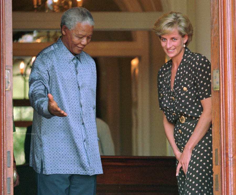 South African President Nelson Mandela shows the way to Princess Diana in Cape Town, South Africa, where they discussed the threat of AIDS in the country, on March 17, 1997 five months before she was killed in a Paris car wreck.