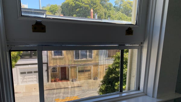 An adjustable window screen in use.