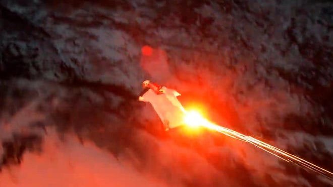 Norwegian skydiver, Andreas Hemli, uses a flare to navigate his wingsuit at night while he jumps off the mountainside and glides through the valley.