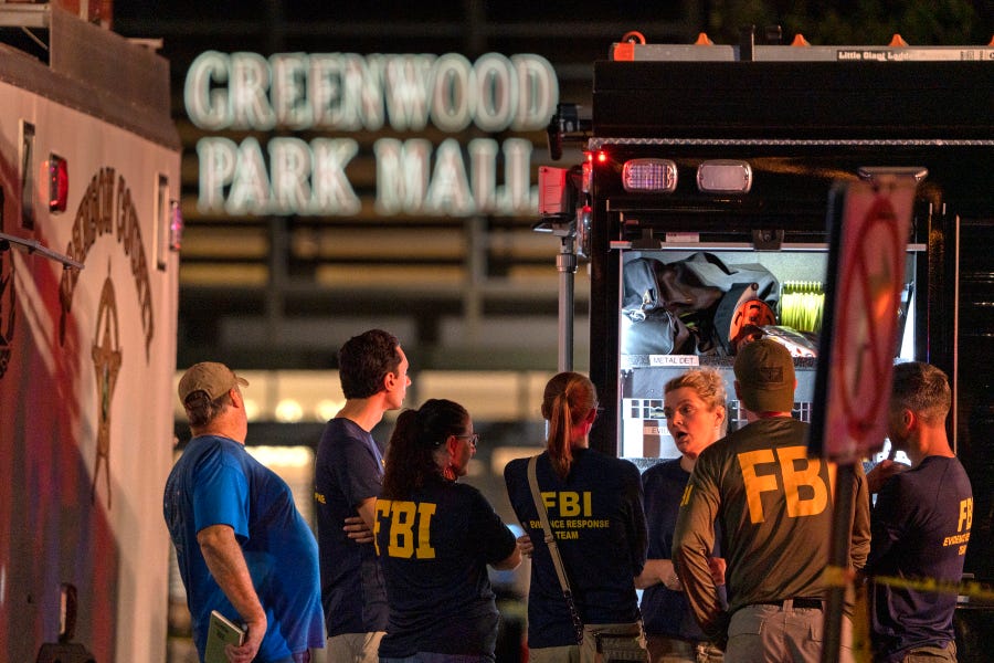FBI agents gather at the scene of a deadly shooting at the Greenwood Park Mall, in Greenwood, Indiana.