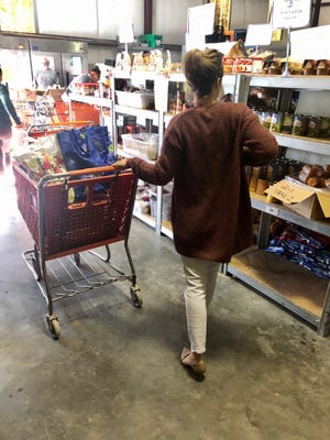 A visitor at a food pantry for Share the Table, Inc. The organization is raising money to build a new facility near U.S. 17.