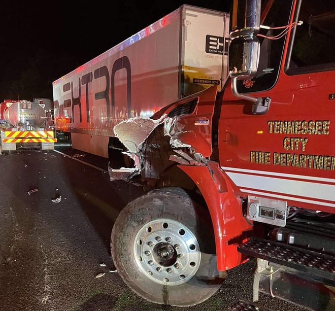 A Tennessee City Volunteer Fire Department firefighter and trucks were hit on Interstate 40 in Hickman County on Monday night.