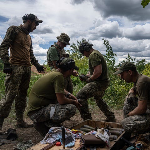 Ukrainian servicemen clean mortar shells during tr