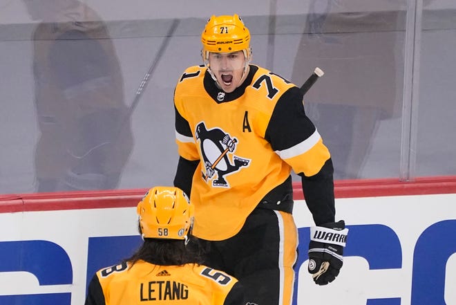 Pittsburgh Penguins' Evgeni Malkin (71) celebrates his goal during the first period in Game 5 of an NHL hockey Stanley Cup first-round playoff series against the New York Islanders n Pittsburgh, Monday, May 24, 2021. (AP Photo/Gene J. Puskar)