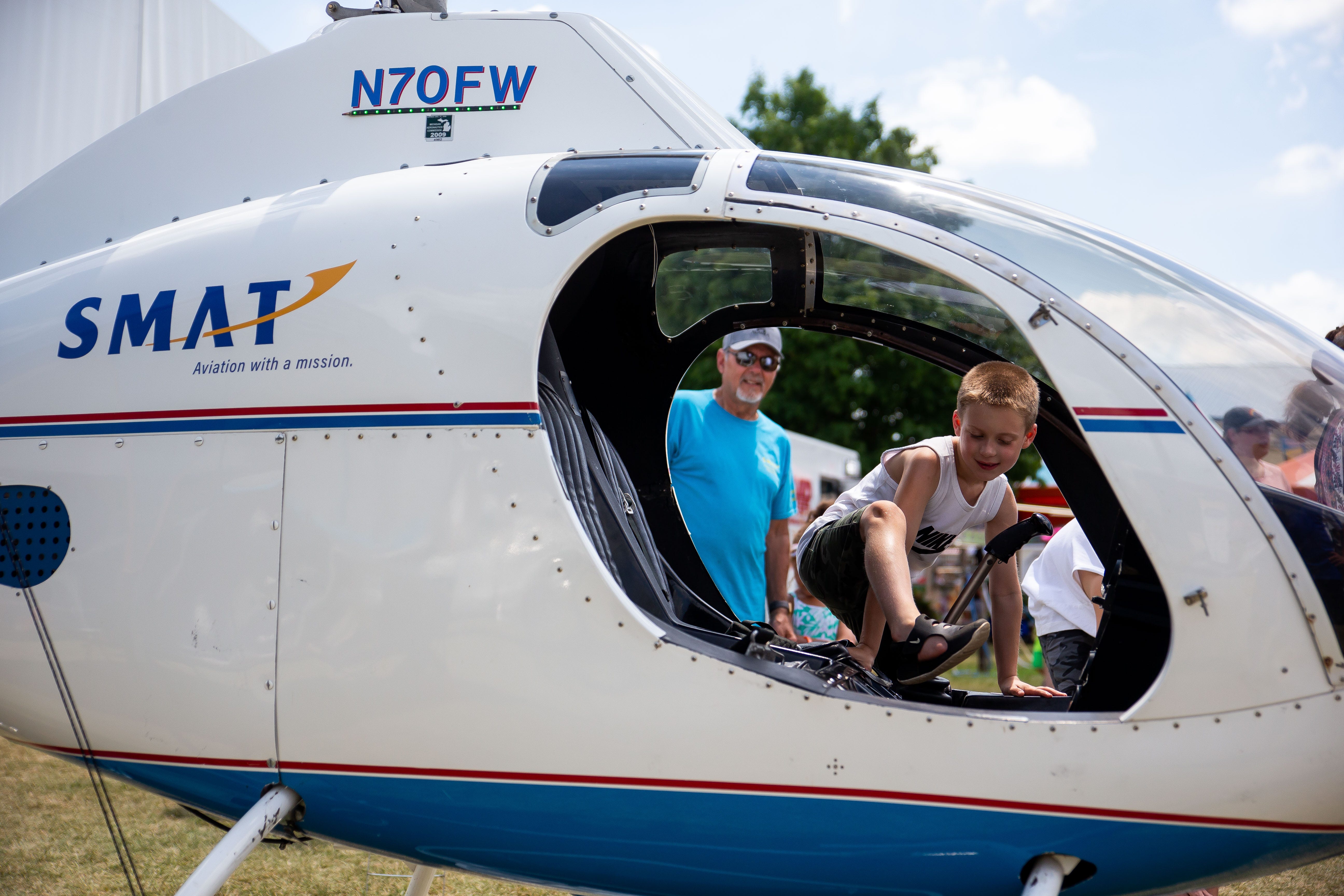 Cain Johnson climbs into a helicopter during Kids Day Tuesday, July 19, 2022, at the Ionia Free Fair.