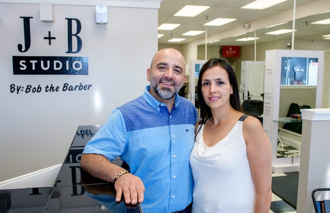 Bob and Joyce Khoury pose at their new barbershop in Campustown, the second location for J+B Studio by Bob the Barber in Peoria. The couple opened a shop at 2302 W. Glen Ave. in May 2020.