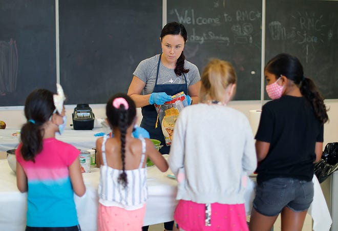 Mary Kate Fay of the Kids Test Kitchen works with kids at the Rockland Community Center. She's teaching them how to select good food and prepare a healthy meal on Wednesday, July 20, 2022.