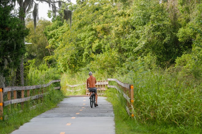FILE: A bicycle rider takes the Truman Linear Park Trail toward Lake Mayer. Although TSPLOST failed, the city is continuing to build out the connected trail infrastructure and is looking for new ways to inject funding into the project.