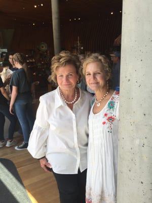 Nancy McGraw at the Crystal Bridges art show in Bentonville with a customer wearing her new pearl necklace.