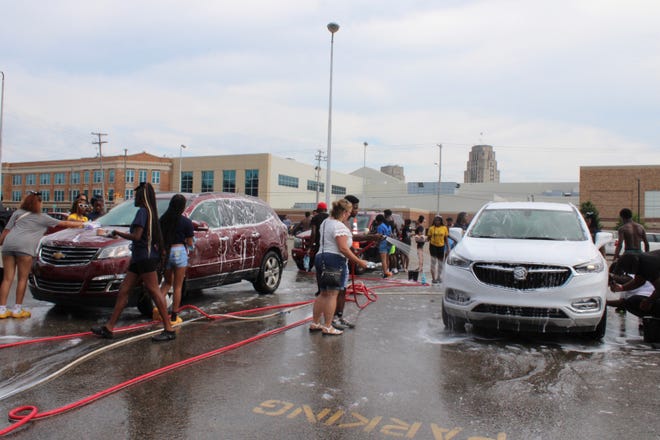 Battle Creek Central students wash vehicles during a fundraiser on Tuesday, July 19, 2022, at C.W. Post Stadium in Battle Creek. The students raised more than $5,000 toward funeral expenses for 17-year-old Christopher Williams.