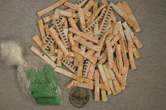 Packets of heroin wrapped in lottery tickets, and a bundle of heroin laced with fentanyl, ready to be sold on the streets, seized by the Wayne County Sheriff Department.