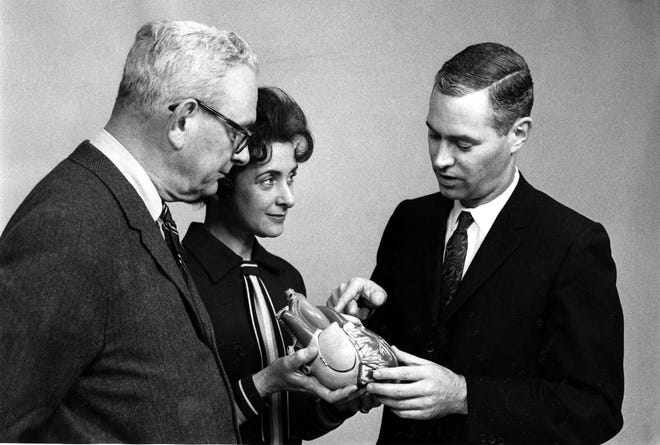 Dr. Allan M. Lansing, right, head of the heart and kidney transplant team at the University of Louisville, uses a heart model to demonstrate how the human heart works in 1968. The U of L was working towards a heart transplant. Joining Lansing are Lamar D. Roy., president of the 1968 Heart Fund Appeal for the Heart Association of Louisville and Jefferson County, and Mrs. Walter S. Coe, president of the Heart Sunday appeal on February 25.