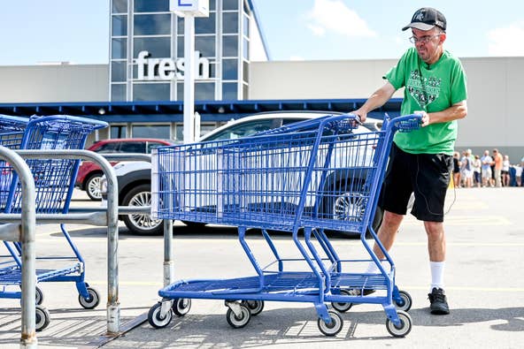 Dave Esch demonstrates returning carts on Wednesday, July 20, 2022, at the Meijer in Grand Ledge. Esch was celebrated for returning his millionth shopping cart as an employee of the store.