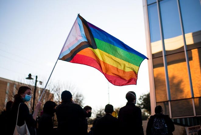 A protester waves a pride flag during a protest at the University of North Texas in March. On Tuesday, the U.S. House voted to codify into federal law the right to same-sex marriage.