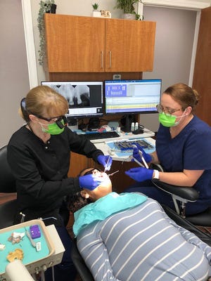 Dr. Mary Martin provides a patient with dental care.