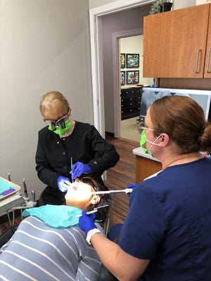 Dr. Mary Martin provides a patient with dental care.