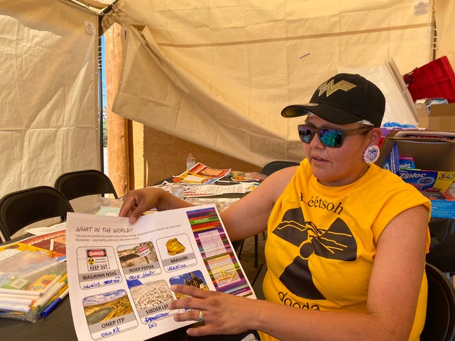 Teracita Keyanna, a community member and member of the Red Water Pond Road Community Association, shows the learning resources she uses to teach the kids about uranium in their communities.