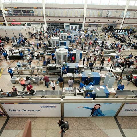 FILE - Travelers queue up at the south security ch