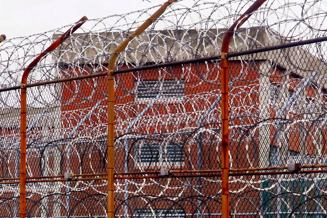 A security fence surrounds inmate housing at a correctional facility in New York.