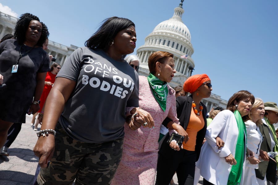 Rep. Cori Bush (D-MO) (2nd L), Rep. Nydia Velazquez (D-NY), Rep. Ilhan Omar (D-MN), Rep. Jackie Speier (D-CA), and Rep. Carolyn Maloney (D-NY), walk from the U.S. Capitol Building to join a protest with activists from the Center for Popular Democracy Action (CPDA) on July 19, 2022 in Washington, DC.