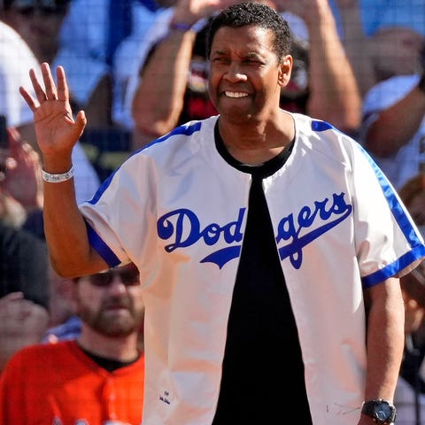 Actor Denzel Washington waves to the crowd before 
