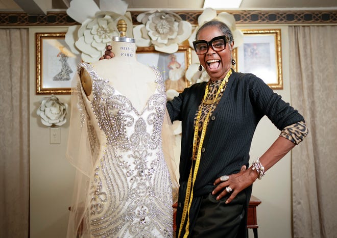 Joan Madison, the designer behind Joan's Bridal Couture, stands with a wedding gown that she is creating inside her Reynoldsburg store and workspace on July 21, 2022. Adam Cairns-The Columbus Dispatch