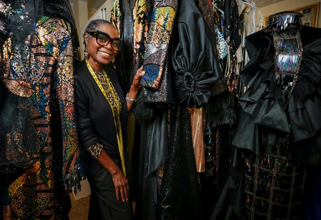 Joan Madison, the designer behind Joan's Bridal Couture, stands with her collection titled Uthabiti inside her Reynoldsburg store and workspace on July 21, 2022. Adam Cairns-The Columbus Dispatch