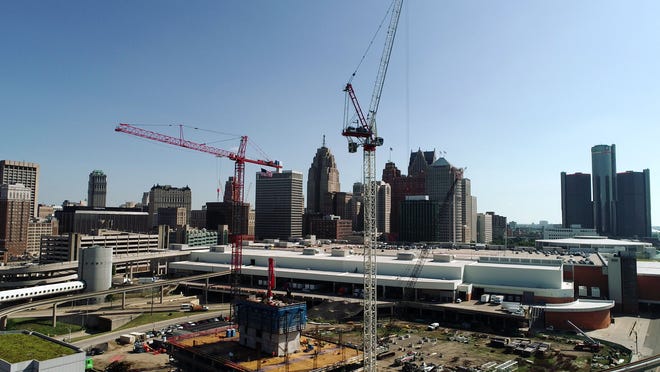 Cranes become part of the skyline as they stand over the construction site at the former Joe Louis Arena near the riverfront in Detroit on July 21, 2022.