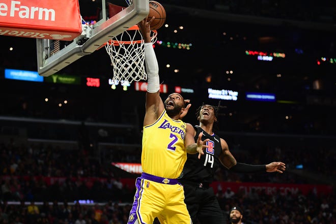 Lakers guard Wayne Ellington moves to the basket past Clippers guard Terance Mann in Los Angeles, March 3, 2022.