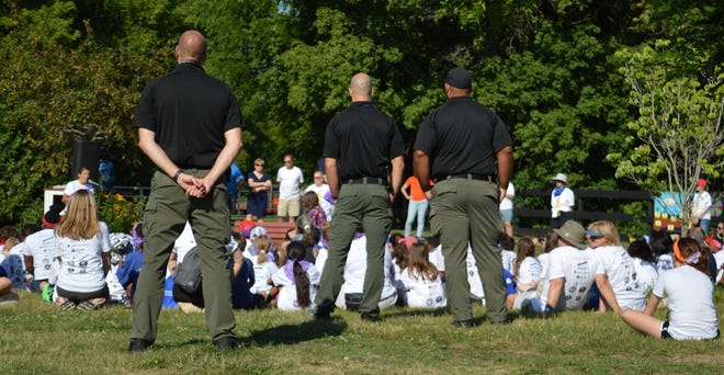 Metro Detroit police officers are a notable presence at this year's  Maybury Farm day camp hosted by Northville-based New Hope Center For Grief Support.  Here, both children and officers gather for the July 21, 2022, opening statements.
