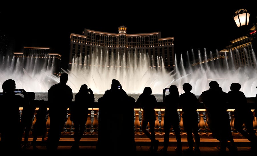 Visitors are silhouetted as they watch The Fountains of Bellagio on May 31, 2021 in Las Vegas, Nevada.