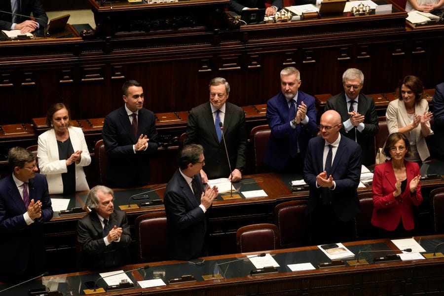 Italian Premier Mario Draghi, background center, delivers his speech at the Parliament in Rome, Thursday, July 21, 2022. Italian Premier Mario Draghi has won a confidence vote in the Senate, but boycotts by three of his key coalition allies in the voting seem likely to have doomed the government's prospects of survival.