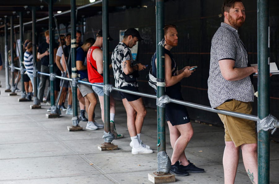 People wait in line to recieve the Monkeypox vaccine before the opening of a new mass vaccination site at the Bushwick Education Campus in Brooklyn on July 17, 2022, in New York City.