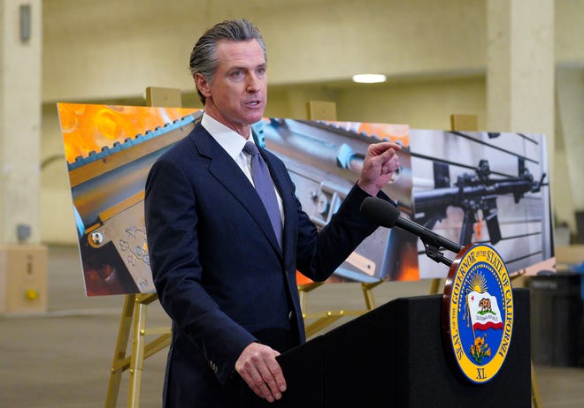 California Gov.  Gavin Newsom speaks to reporters at the Del Mar Fairgrounds on Feb.  18, 2022, in Del Mar, Calif.  Newsom announced Friday, July 22, he will sign a controversial, first-in-the-nation gun control law patterned after a Texas anti-abortion law.