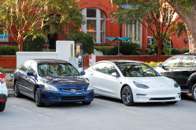 A Tesla charges at the Chargepoint space in Forsyth Park.