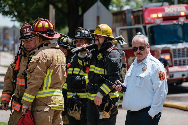 Dover Fire Chief Russell Volkert Friday runs command at a fire in the 700 block of North Tuscarawas Ave., July 22 in Dover. The cause of the fire was food left on a stovetop, and no injuries were reported. Crews from New Philadelphia, Bolivar, and Smith Ambulance responded to the scene,