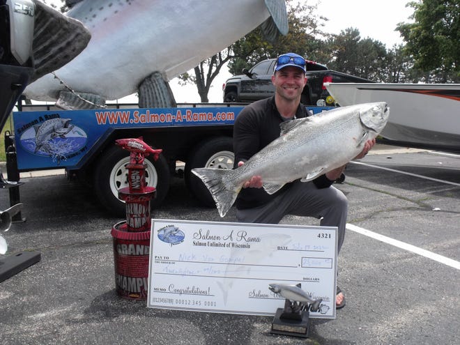Nick Van Gompel of Cedarburg displays the 34.94-pound chinook salmon he caught July 12 while kayak fishing in Lake Michigan. The fish won the grand prize of the 2022 Salmon-A-Rama fishing tournament, including $21,250 in cash and an outboard motor.