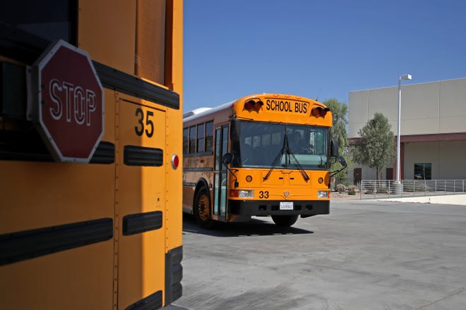Coachella Valley Unified School District driver instructor Mary Romero drives a bus at the transportation facility in Thermal, Calif., on July 18, 2022. 